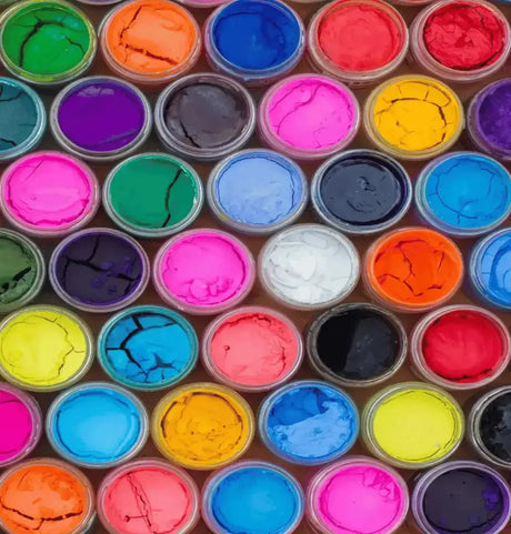 Vibrant color paints in containers illustrating creativity with Go Print Plus as your perfect print partner.