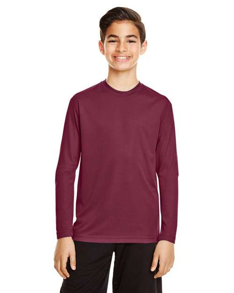 Team 365 Youth Zone Performance long sleeve t-shirt with a lightweight, breathable design and athletic fit. Features moisture-wicking fabric, making it ideal for sports, school, or everyday active wear.