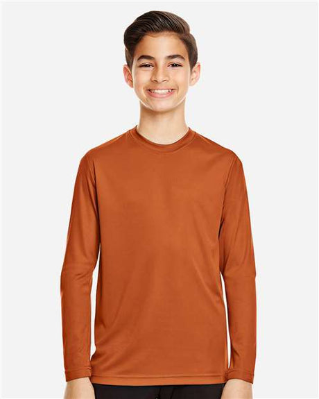 Team 365 Youth Zone Performance long sleeve t-shirt with a lightweight, breathable design and athletic fit. Features moisture-wicking fabric, making it ideal for sports, school, or everyday active wear.