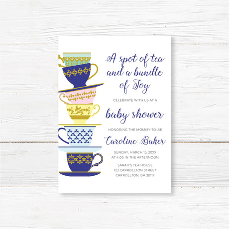 A Spot of Tea baby shower invitation featuring an elegant stack of colorful teacups with gold and blue patterns. The design includes delicate script typography with customizable text for the honoree’s name, event date, time, and venue. Perfect for a tea party-themed baby shower, afternoon tea, or high tea celebration. Professionally printed on premium cardstock with matching envelopes included.