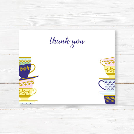 A Spot of Tea baby shower thank you featuring an elegant stack of colorful teacups with gold and blue patterns. The design includes delicate script typography with customizable text for the honoree’s name, event date, time, and venue. Perfect for a tea party-themed baby shower, afternoon tea, or high tea celebration. Professionally printed on premium cardstock with matching envelopes included.