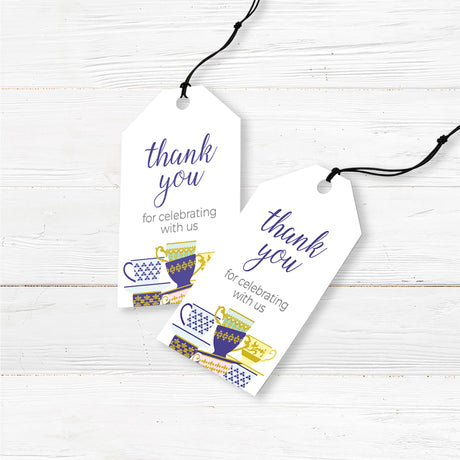 A Spot of Tea baby shower favor tags featuring an elegant stack of colorful teacups with gold and blue patterns. The design includes delicate script typography with customizable text for the honoree’s name, event date, time, and venue. Perfect for a tea party-themed baby shower, afternoon tea, or high tea celebration. Professionally printed on premium cardstock with matching envelopes included.