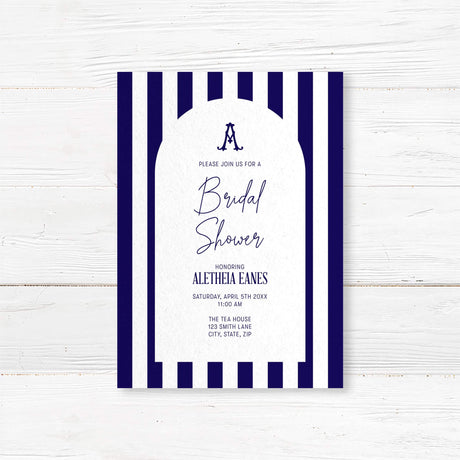 Bridal shower welcome sign with navy and white vertical stripes, antique serif monogram, elegant modern script and serif fonts, and a white arch panel to welcome guests in style.