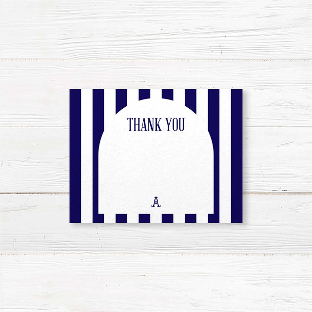 Thank you card featuring navy and white vertical stripes, serif monogram crest, clean modern script and serif typography, and a white arched center panel. Matches the Antique Bridal Shower suite.