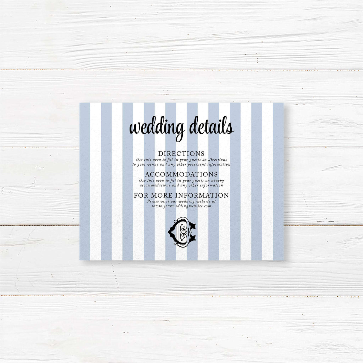 Wedding detail card with vertical blue and white stripes and black monogram crest, used to share venue directions, hotel info, dress code, or other event details.