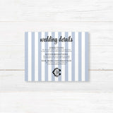 Wedding detail card with vertical blue and white stripes and black monogram crest, used to share venue directions, hotel info, dress code, or other event details.