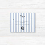 Wedding RSVP card featuring matching blue and white vertical stripes, a coordinating black monogram crest, and traditional RSVP response format with elegant typography.