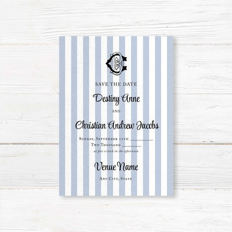 Wedding Save the Date card with blue and white stripes, black crest monogram, and classic serif and script fonts, perfect for previewing a stylish and formal wedding.