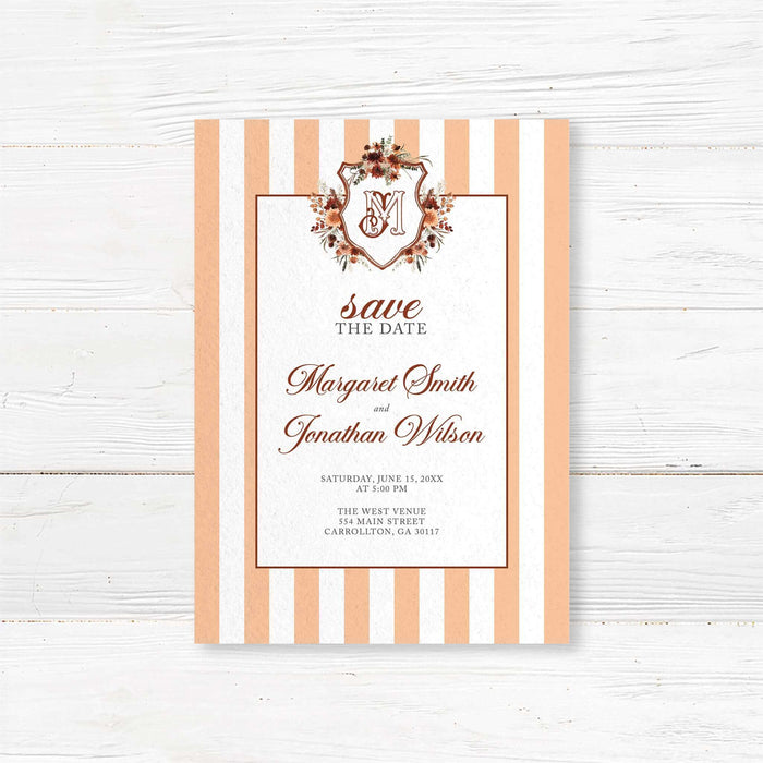 A striped  autumn crest save the date card with a floral crest and monogram. The design features warm autumn colors and elegant text.