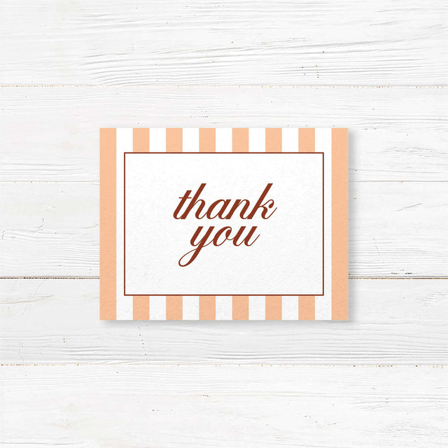 Printed thank you card with floral monogram crest, peach and terracotta stripes, and elegant fonts matching an autumn wedding suite in rustic fall colors.