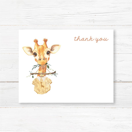 Printed baby shower thank you card featuring a watercolor baby giraffe illustration holding a baby onesie on a wooden hanger. Designed with soft, neutral colors for a gender-neutral appeal. Printed on high-quality cardstock, available in folded or flat styles with optional envelopes. Perfect for sending a heartfelt thank-you message after a jungle, safari, or boho baby shower. Coordinates with the full giraffe-themed baby shower stationery set.