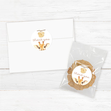 Printed baby shower favor stickers featuring a watercolor baby giraffe illustration holding a baby onesie. These premium-quality adhesive labels are ideal for sealing favor bags, honey jars, mini candles, or thank-you gifts. Printed on durable, waterproof labels with an easy peel-and-stick application. A perfect addition to safari, jungle, or neutral baby showers. Available in multiple sizes for different packaging needs.