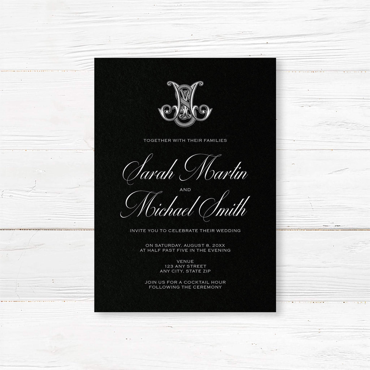 Wedding invitation with ornate Celtic-style monogram, white script and sans serif fonts, and a dramatic black background designed for formal, black-tie, or Celtic-inspired weddings.