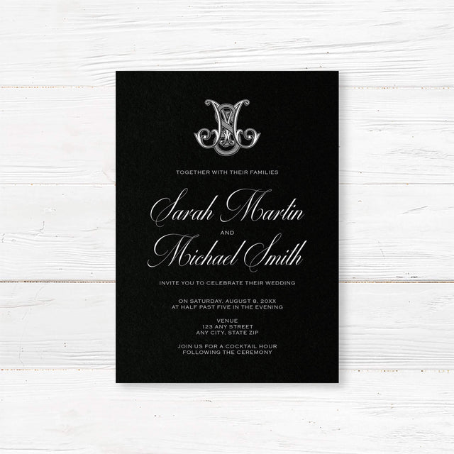 Wedding invitation with ornate Celtic-style monogram, white script and sans serif fonts, and a dramatic black background designed for formal, black-tie, or Celtic-inspired weddings.