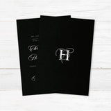 Elegant wedding invitation featuring a solid black background, ornate white monogram at the top, white serif and flourished calligraphy script fonts, and a formal centered layout for black-tie weddings. - back side