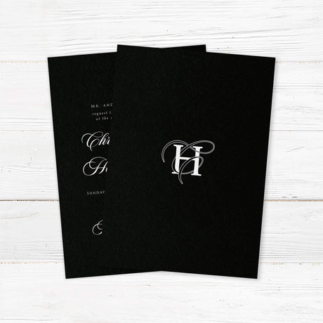 Elegant wedding invitation featuring a solid black background, ornate white monogram at the top, white serif and flourished calligraphy script fonts, and a formal centered layout for black-tie weddings. - back side