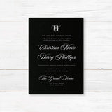 Elegant wedding invitation featuring a solid black background, ornate white monogram at the top, white serif and flourished calligraphy script fonts, and a formal centered layout for black-tie weddings.