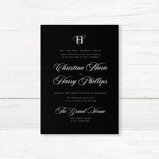 Elegant wedding invitation featuring a solid black background, ornate white monogram at the top, white serif and flourished calligraphy script fonts, and a formal centered layout for black-tie weddings.