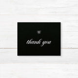 Wedding thank you card with black background, elegant white serif and script fonts, and refined formal layout to coordinate with the Black Entwined Initials wedding suite.