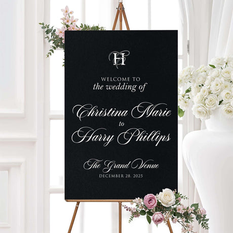 Wedding welcome sign with black background, white ornate monogram crest, and elegant serif and calligraphy fonts, matching the Black Entwined Initials wedding suite.