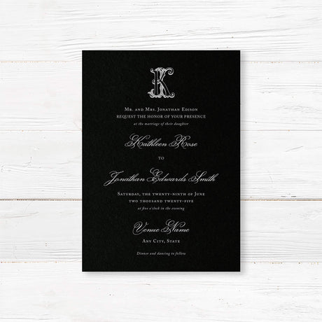 Wedding invitation with a black background, ornate Celtic monogram, and a blend of white script and serif fonts. A dramatic and elegant choice for formal or Celtic-inspired weddings.
