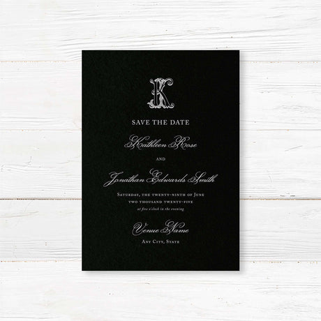 Save the Date card featuring a black background, ornate Celtic monogram crest, and elegant white serif and script fonts for formal and black-tie wedding themes.