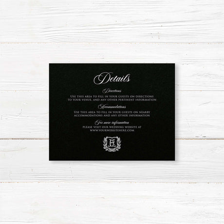 Wedding detail card with a black background, white serif and script fonts, and vintage shield monogram wreath accent. Ideal for formal or vintage wedding stationery suites.