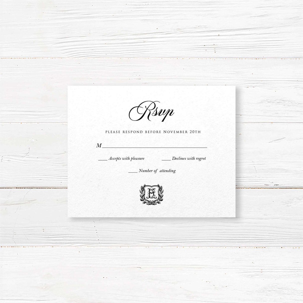 Wedding RSVP card with black background, white serif and script fonts, and a matching shield monogram design to coordinate with the Black Wreath Monogram invitation suite.
