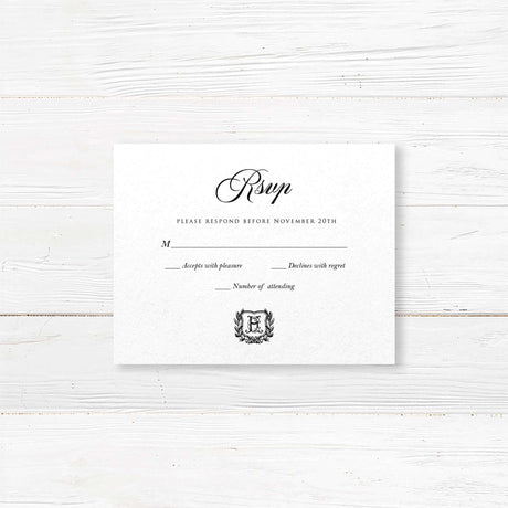Wedding RSVP card with black background, white serif and script fonts, and a matching shield monogram design to coordinate with the Black Wreath Monogram invitation suite.