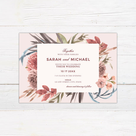 A wedding invitation with a soft neutral background features a beautiful watercolor floral arrangement in warm earthy tones of blush, burgundy, and green. The text is elegantly arranged in a mix of serif and script fonts within a centered cream-colored rectangle. Event details, including the date, time, and venue, are displayed in a structured and refined layout. This design exudes rustic elegance, perfect for boho, autumn, or garden-inspired wedding celebrations.