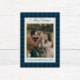 Blue plaid Christmas photo card featuring a family photograph with elegant script, gold accents, and personalized family text. The coordinating back features large gold JOY lettering with a faith-inspired Christmas message.