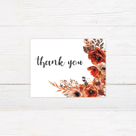 A note card with a background featuring stunning watercolor floral arrangement in warm autumn tones of red, orange, and brown. The text is elegantly arranged in a mix of script and serif fonts, creating a sophisticated yet modern feel. Event details, including the date, time, and venue, are clearly displayed in a balanced layout. This design exudes warmth and romance, perfect for a fall, rustic, or boho-theme.