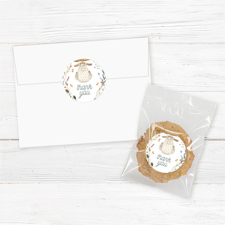 Printed baby shower favor stickers featuring a watercolor baby romper on a rustic wooden hanger with botanical floral accents. These high-quality adhesive labels are perfect for sealing favor bags, mini candles, honey jars, lip balms, or thank-you gifts. Professionally printed on durable, waterproof labels for a premium look. Ideal for a boho, rustic, or floral baby shower theme. Available in multiple sizes and easy to apply for a polished presentation.