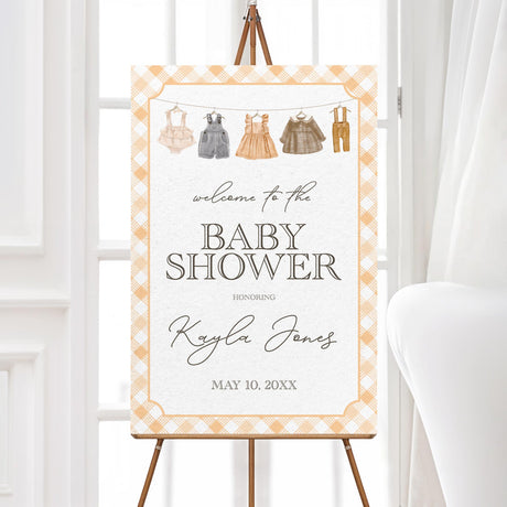 Rustic baby shower welcome sign with a baby clothesline design and gingham border. Professionally printed and ideal for greeting guests at a country baby shower.