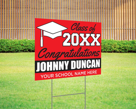 Custom graduation yard sign with bold red and black color block design, featuring a graduation cap graphic, personalized graduate’s name, school, and class year. Printed on durable Coreplast plastic, available in single or double-sided print, perfect for high school and college graduates.