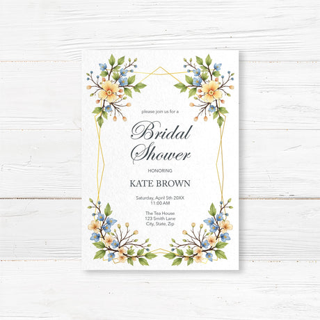 Elegant bridal shower invitation with a gold geometric frame and watercolor floral design in yellow and blue, printed on premium cardstock.