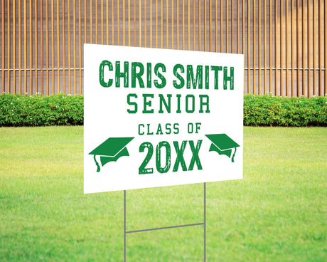 Custom graduation yard sign with a distressed-style font in bold red, featuring personalized senior name, class year, and graduation cap icons. Printed on durable Coreplast plastic, available in custom colors and single or double-sided print, perfect for high school and college graduates. Green