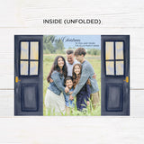 Personalized Doorway to Christmas gatefold card featuring navy blue doors decorated with festive evergreen wreaths, red bows, and elegant gold Merry Christmas lettering. The doors open to reveal a family photograph with a customizable holiday greeting and family name. - inside.