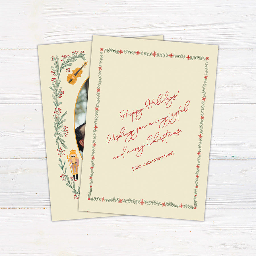 Personalized Christmas photo card featuring an oval family photo surrounded by nutcrackers, greenery, berries, bows, and musical instruments. back