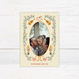 Personalized Christmas photo card featuring an oval family photo surrounded by nutcrackers, greenery, berries, bows, and musical instruments.
