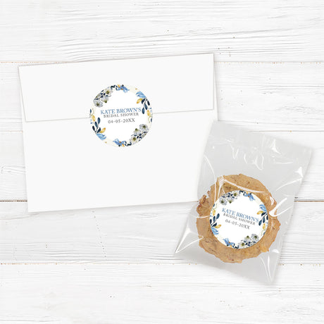 Custom bridal shower stickers featuring watercolor blue and ivory flowers with gold accents, perfect for favors, gifts, and envelope seals.