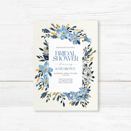 Bridal shower invitation featuring watercolor blue, gold, and ivory flowers with a modern elegant design, printed on premium cardstock.