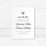 Black and white Save the Date card with elegant monogram and classic script and serif fonts printed on textured cardstock