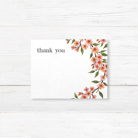 Bridal shower thank-you card featuring a watercolor cherry blossom vine with soft pink flowers and green leaves, printed on premium cardstock.