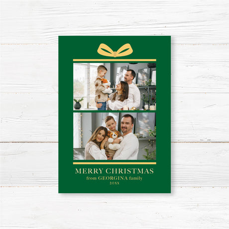 Gift Box Christmas card with green background, golden bow illustration, two family photo placements, and personalized holiday greeting text.