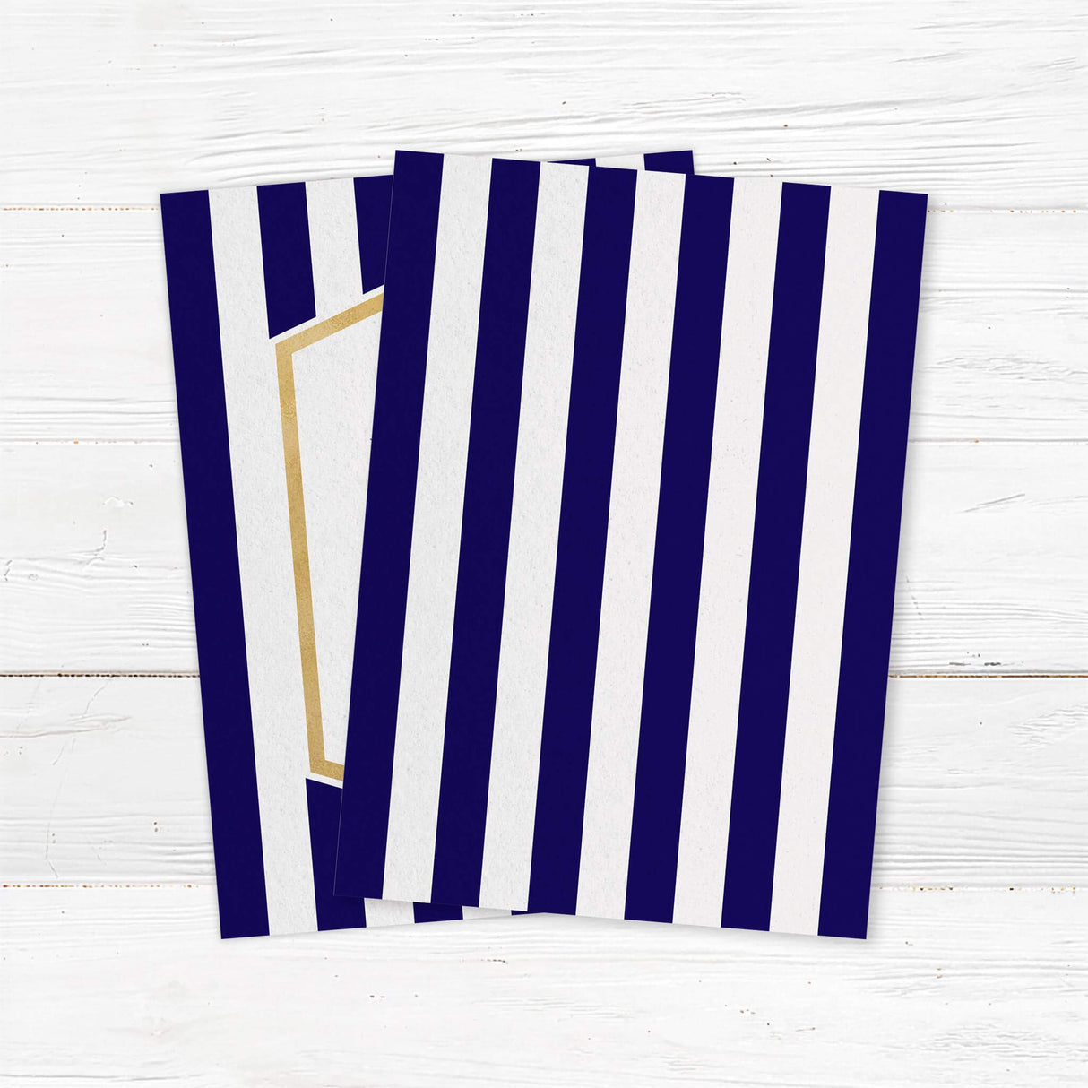 Wedding invitation with navy blue stripes, gold border, and modern white center panel with serif and handwritten fonts - back side