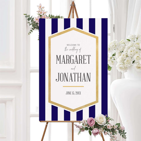Navy striped wedding welcome sign with gold frame and white text panel