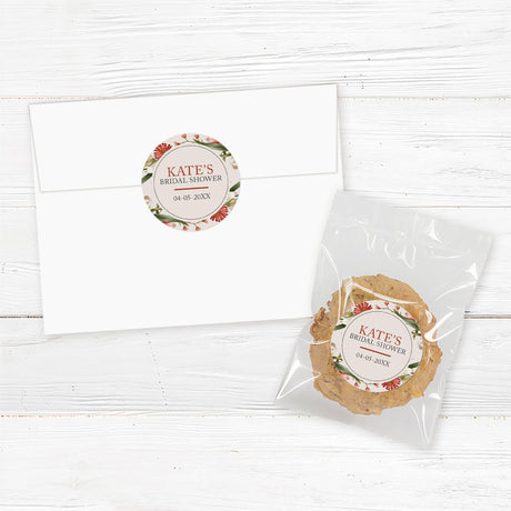 Bridal shower sticker with a red, blush, and beige watercolor floral wreath, perfect for favor bags and envelopes.