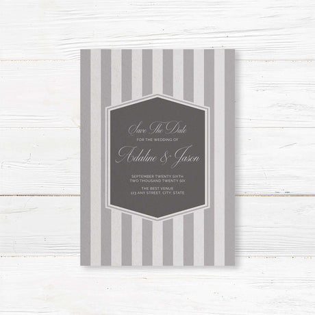 Save the Date card with gray stripes, monogram crest, and elegant serif script fonts