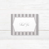 Gray thank you card with vertical stripes, white panel, and monogram crest
